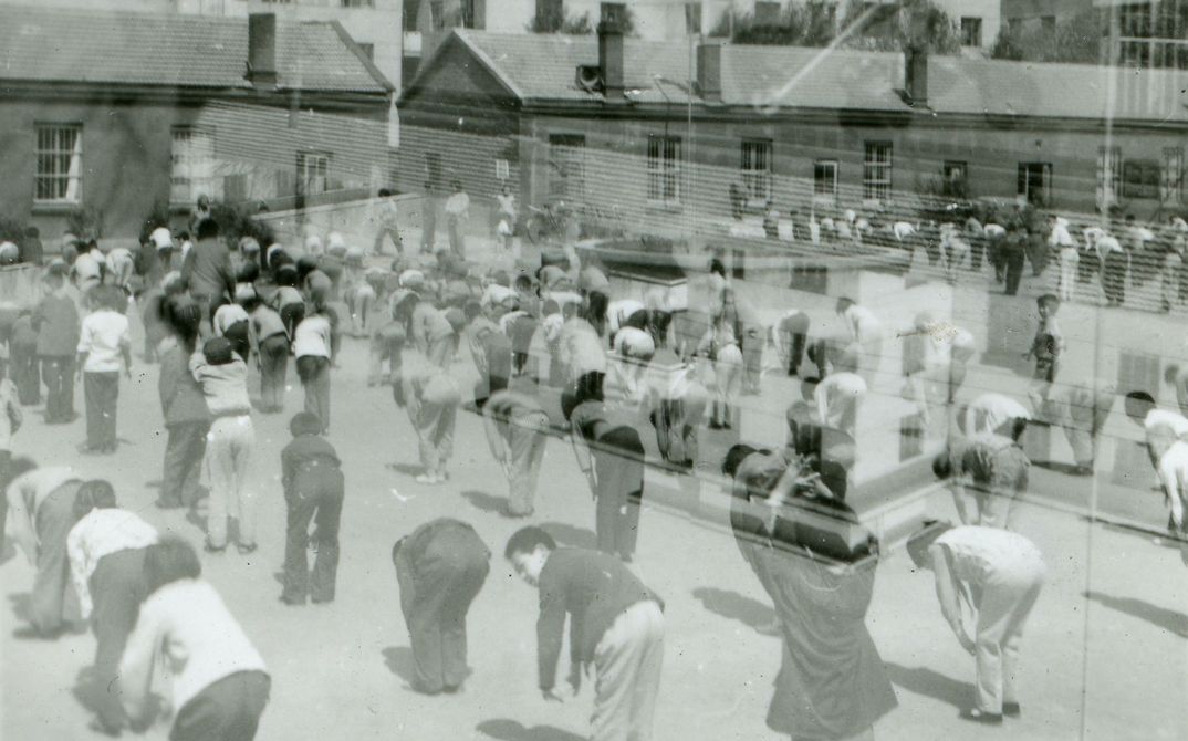 Two black and white images, you can people of different age groups on a public square practising gymnastics.