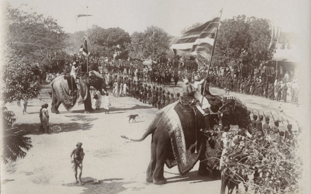 Film still from DELHI DURBAR, 1903: A procession with two richly decorated elephants.