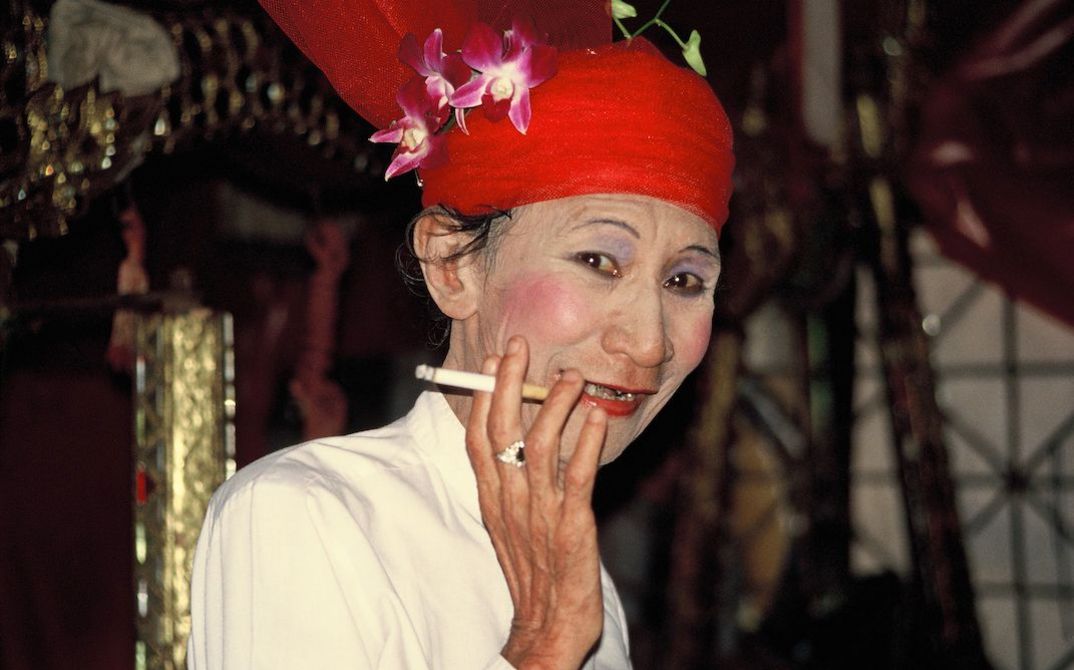 Medium Ah Swan in the persona of “Popa Medaw” nat, smoking