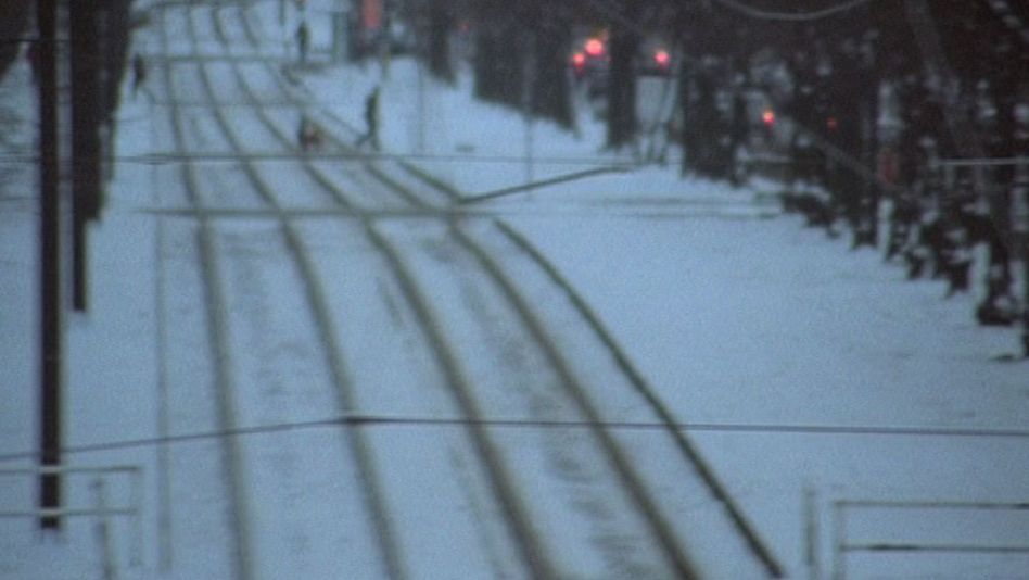 Film still from MATERIAL: Tracks in the snow.