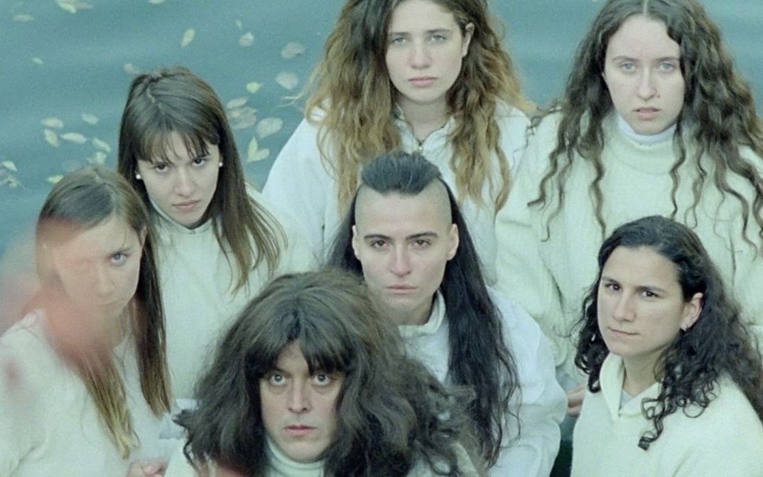 Still from the film „Mammalia“ by Sebastian Mihăilescu. It shows a group of seven people with long hair from a bird