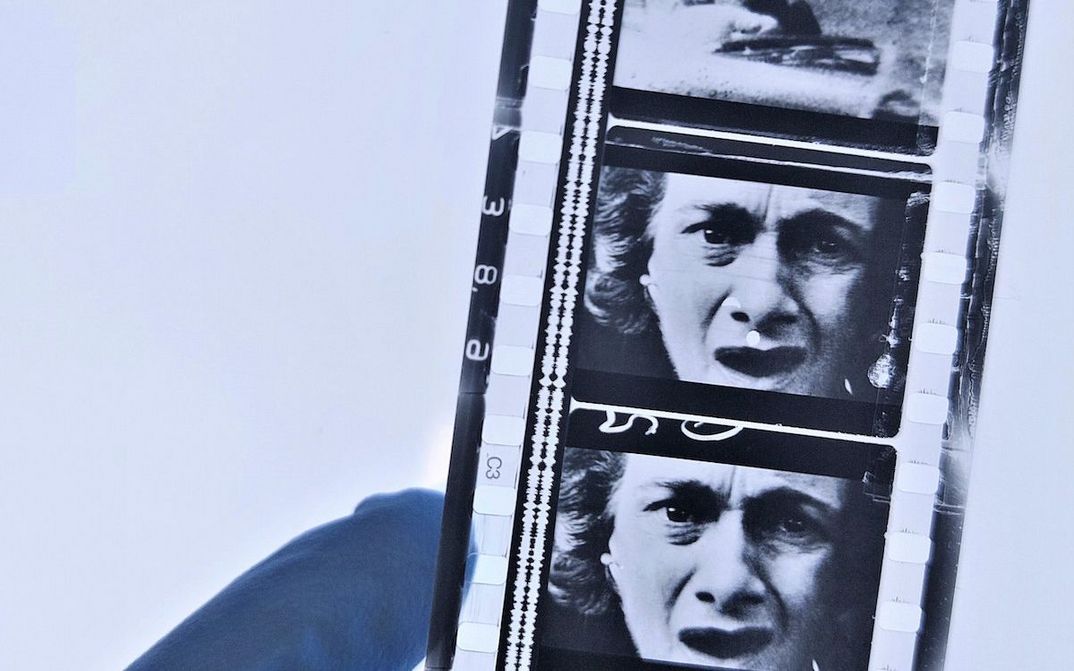 A hand is holding a film strip.