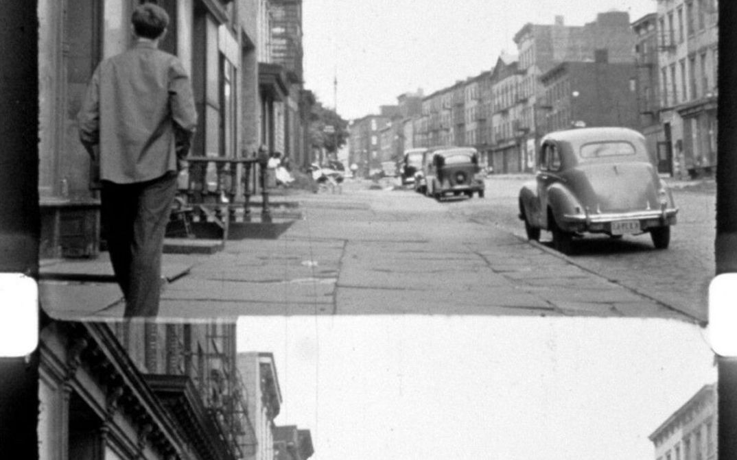 Film still from LOST LOST LOST: You can see a filmstrip with image line and perforation; on the film image a street scene from New York.
