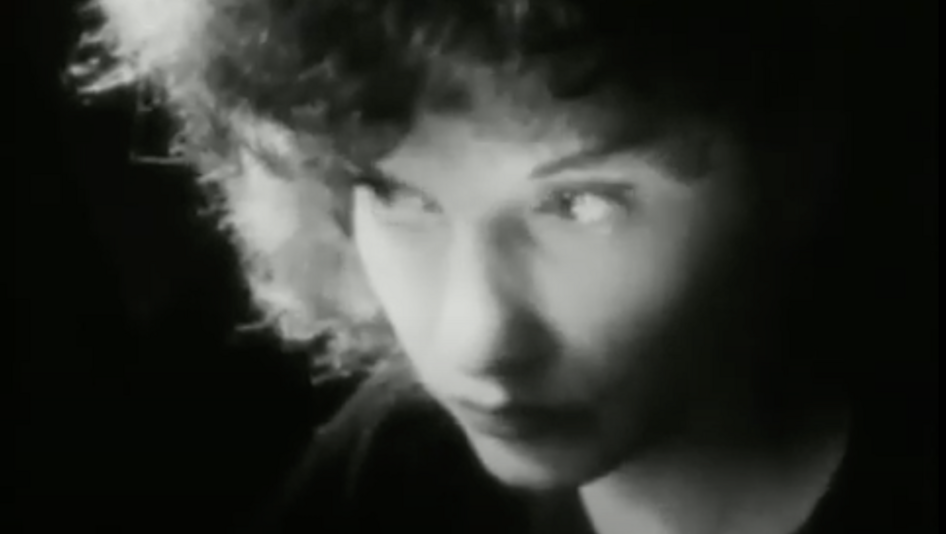 Film still from MESHES OF THE AFTERNOON: Portrait of a young woman in black and white.