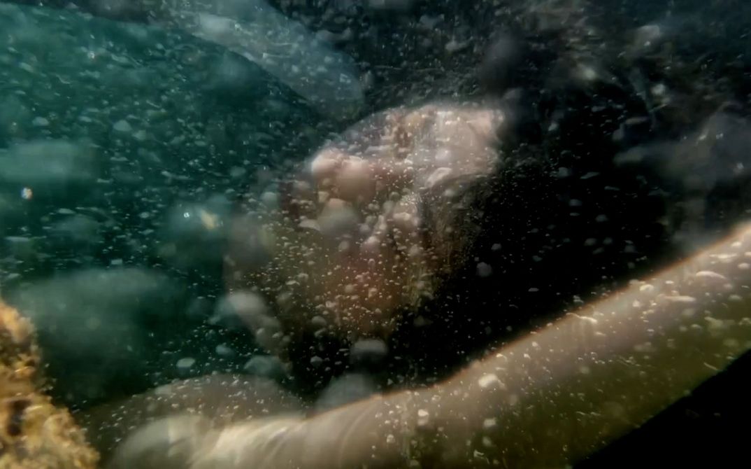 Darkhaired woman under water