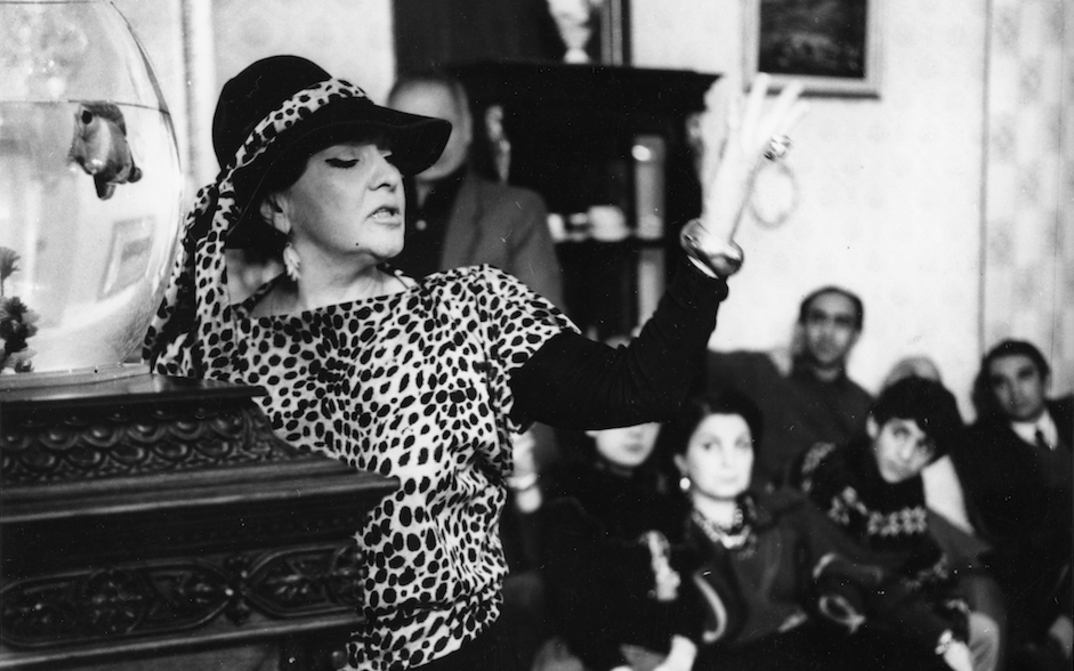 Film still from FULL CIRCLE: An actress performs in front of a group of people.