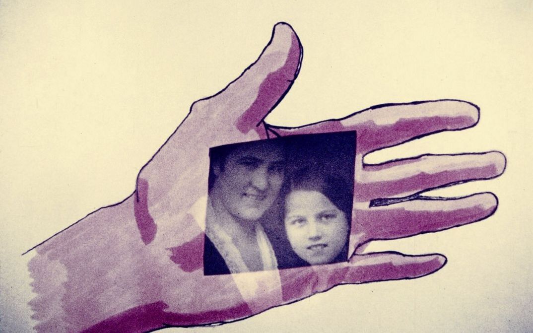 Film still from "Palmistry" by Maria Lassnig. It shows a drawn hand on which lies a photo of a man and a woman.