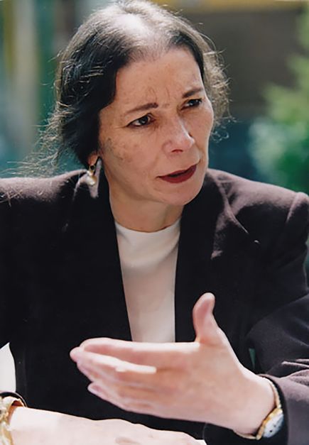 A portrait of the activist and filmmaker Melanie Spitta. She is speaking while looking past the camera to the right.