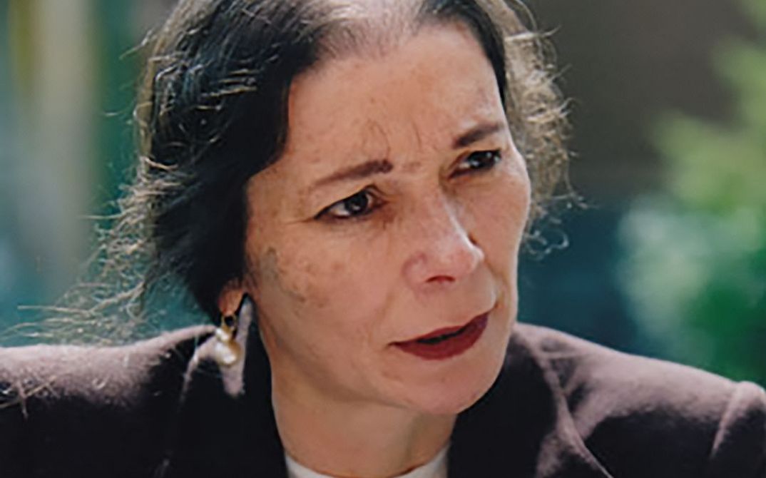 A portrait of the activist and filmmaker Melanie Spitta. She is speaking while looking past the camera to the right.