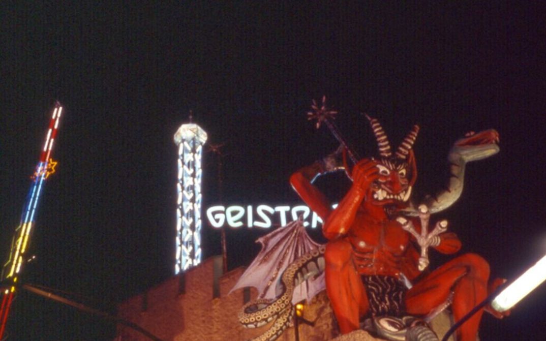 Film still from PRATER: The ride of an amusement park with the figure of a devil.