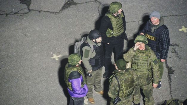 Film still from Oleksiy Radynski’s film “Special Operation”. A group of Russian soldiers filmed in the parking lot of Ukraine