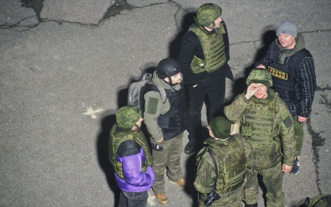 Film still from Oleksiy Radynski’s film “Special Operation”. A group of Russian soldiers filmed in the parking lot of Ukraine